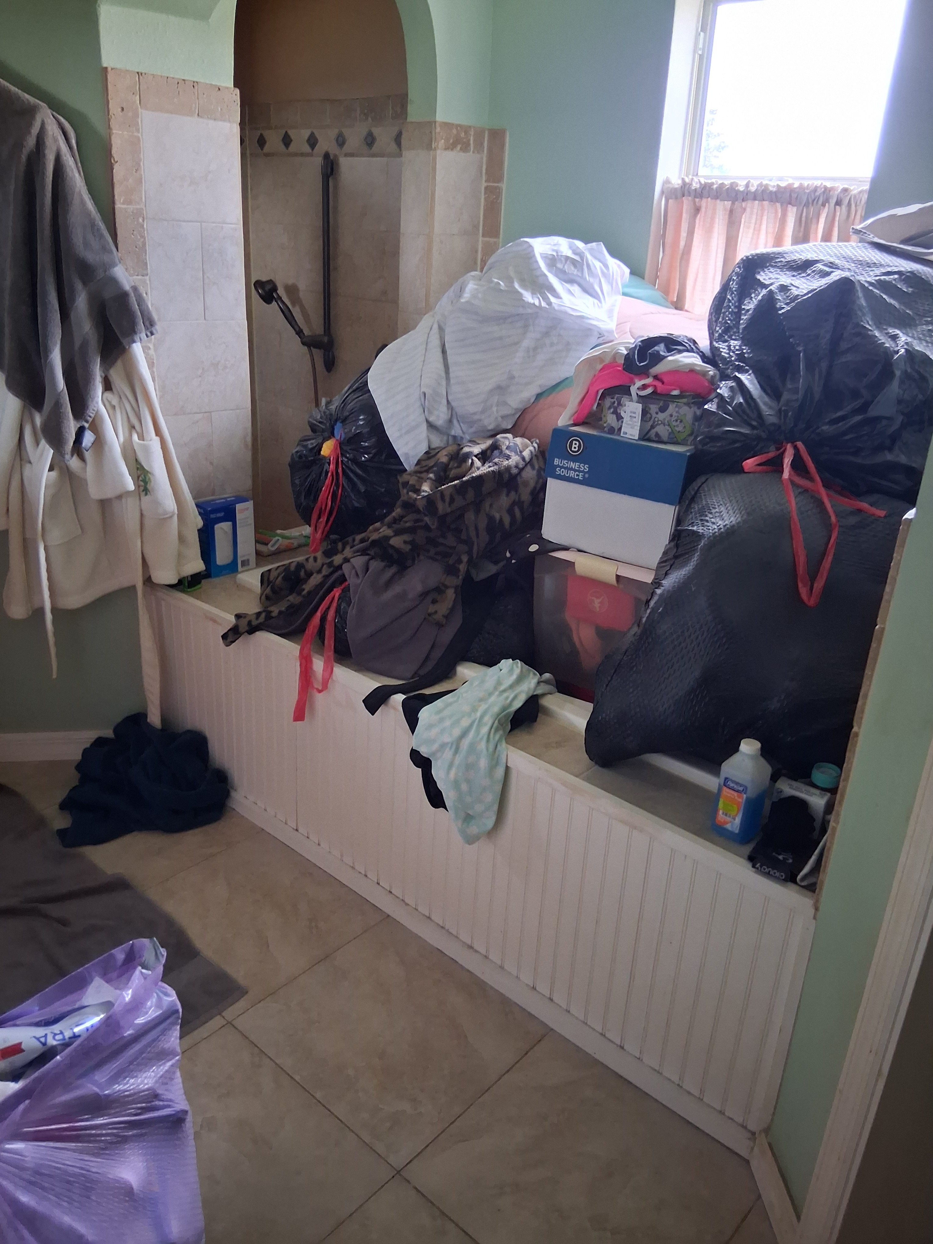 Rate my mess!  Primary bath romance tub used as storage